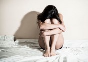 abused woman huddled up